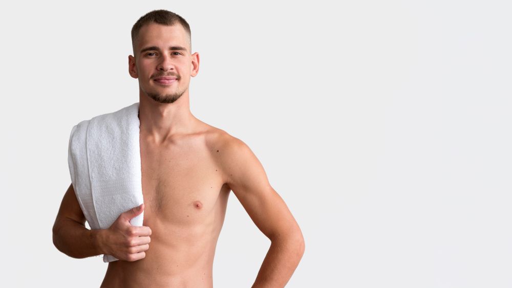 front view shirtless man posing with towel copy space Male brazilian laser hair removal embarrassing? There is a solution!