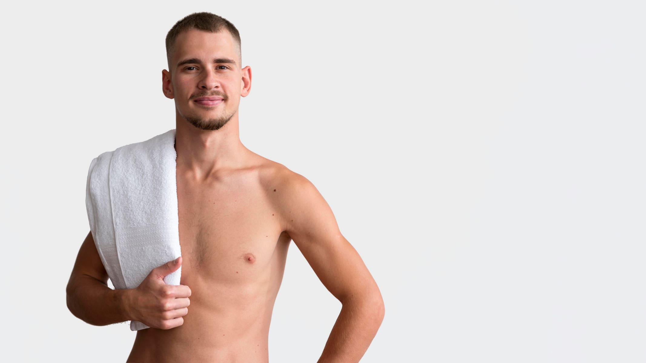 front view shirtless man posing with towel copy space Male brazilian laser hair removal embarrassing? There is a solution!
